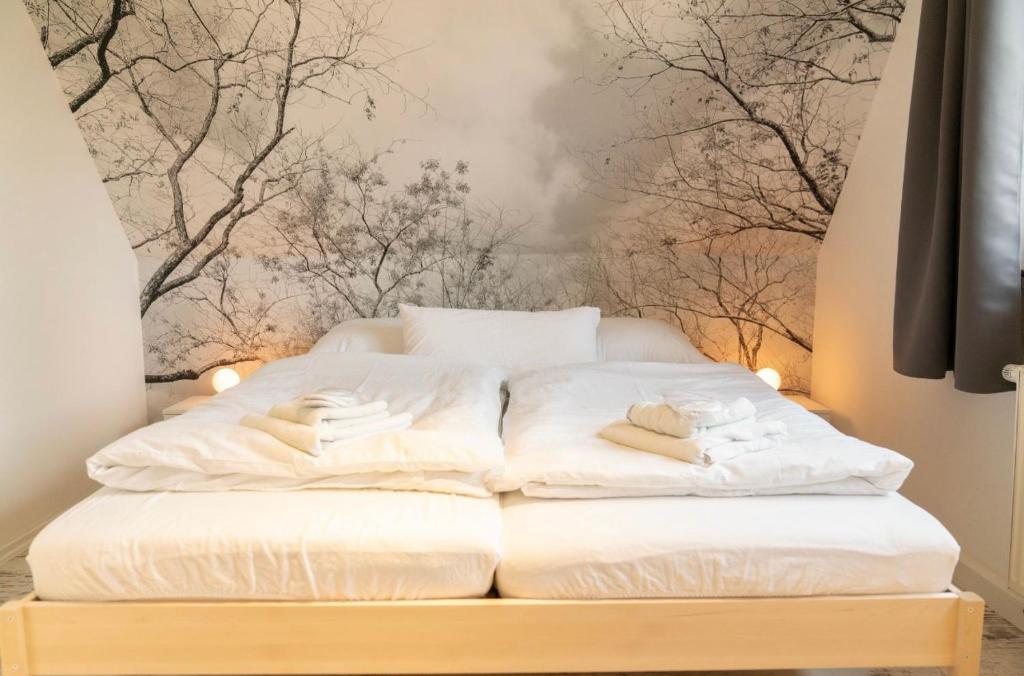 a white bed with two towels on top of it at Ferienhaus Leo in Boblitz