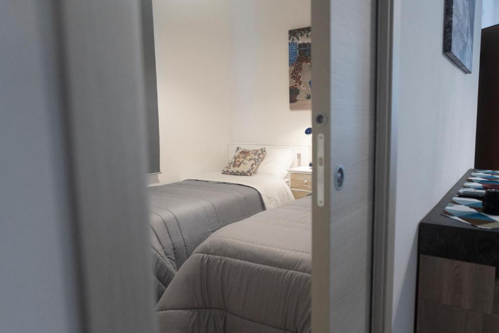 a small room with two beds and a window at MrBrown - Cinzia Resort Beach in Mazara del Vallo