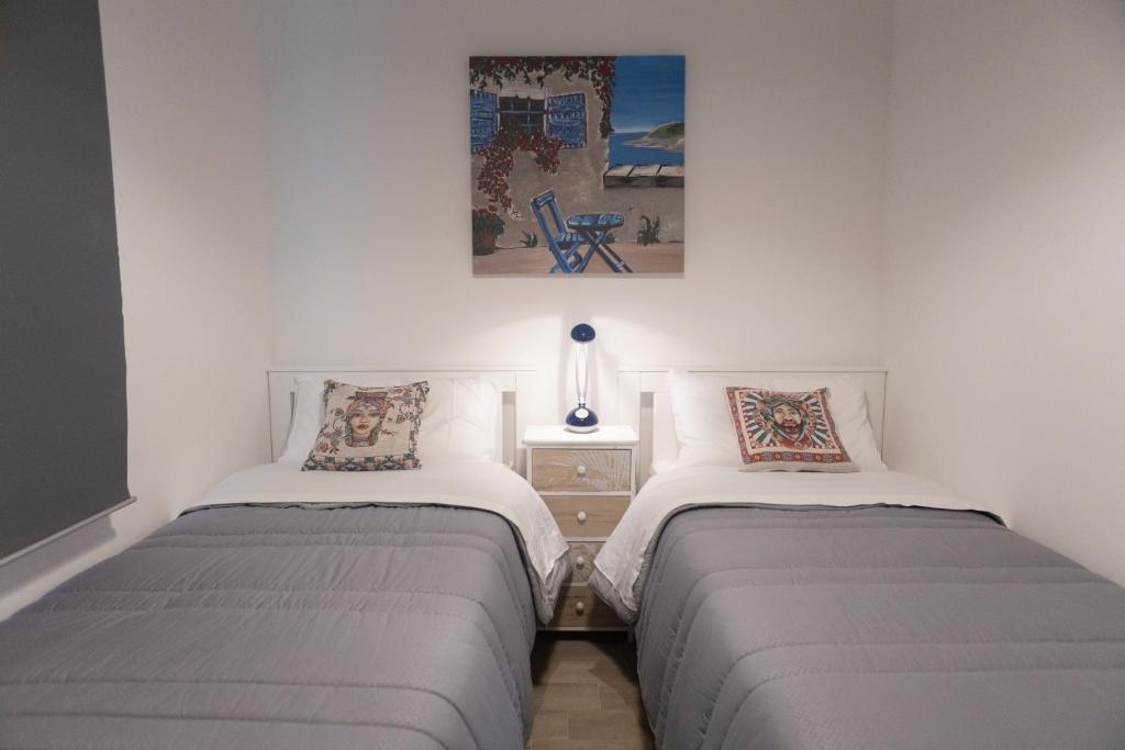 two beds sitting next to each other in a bedroom at MrBrown - Cinzia Resort Beach in Mazara del Vallo