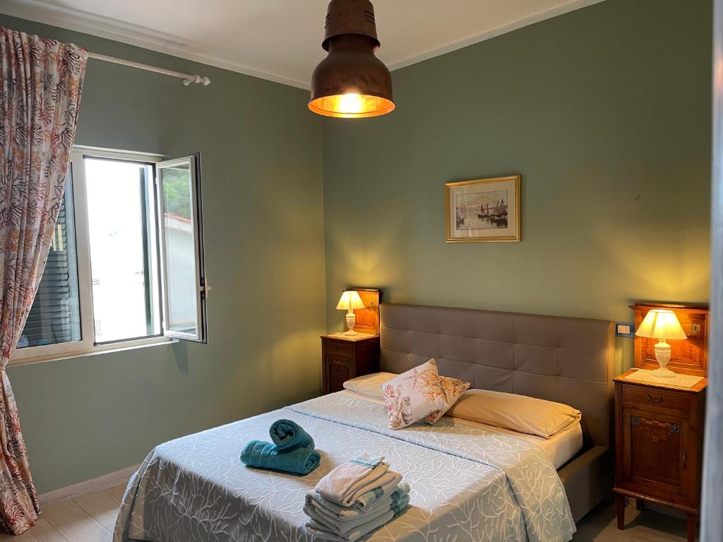 a bedroom with a bed with two towels on it at SUITE Casa MARA & SUITE Casa TEA in Maratea