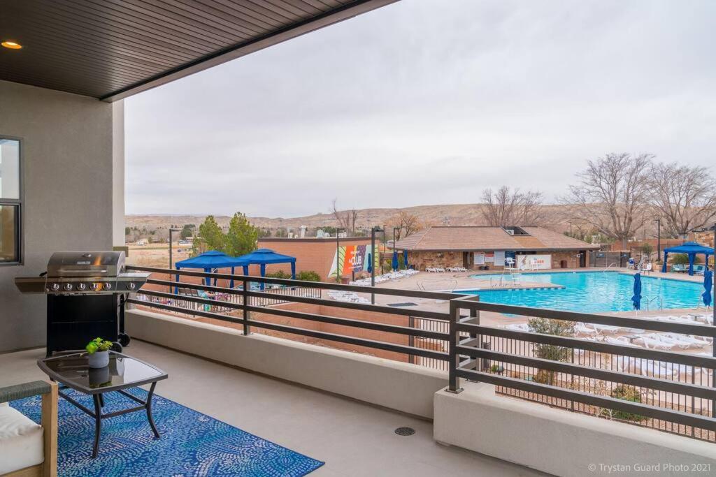 a balcony with a view of a swimming pool at Resort Villa 4 - LUXURY VILLA, POOL VIEW, GAMES GALORE, TOP LEVEL! YEAR ROUND HEATED POOL & HOT TUB! in St. George