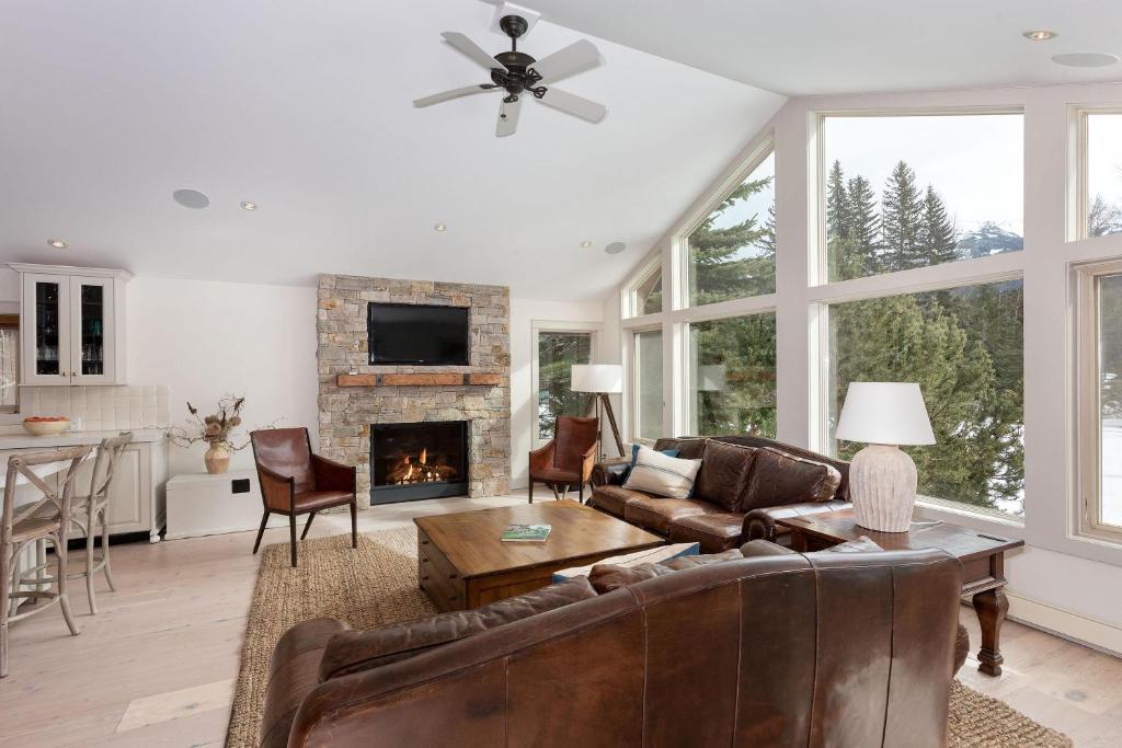 a living room with a couch and a fireplace at 8166 Nicklaus North in Whistler