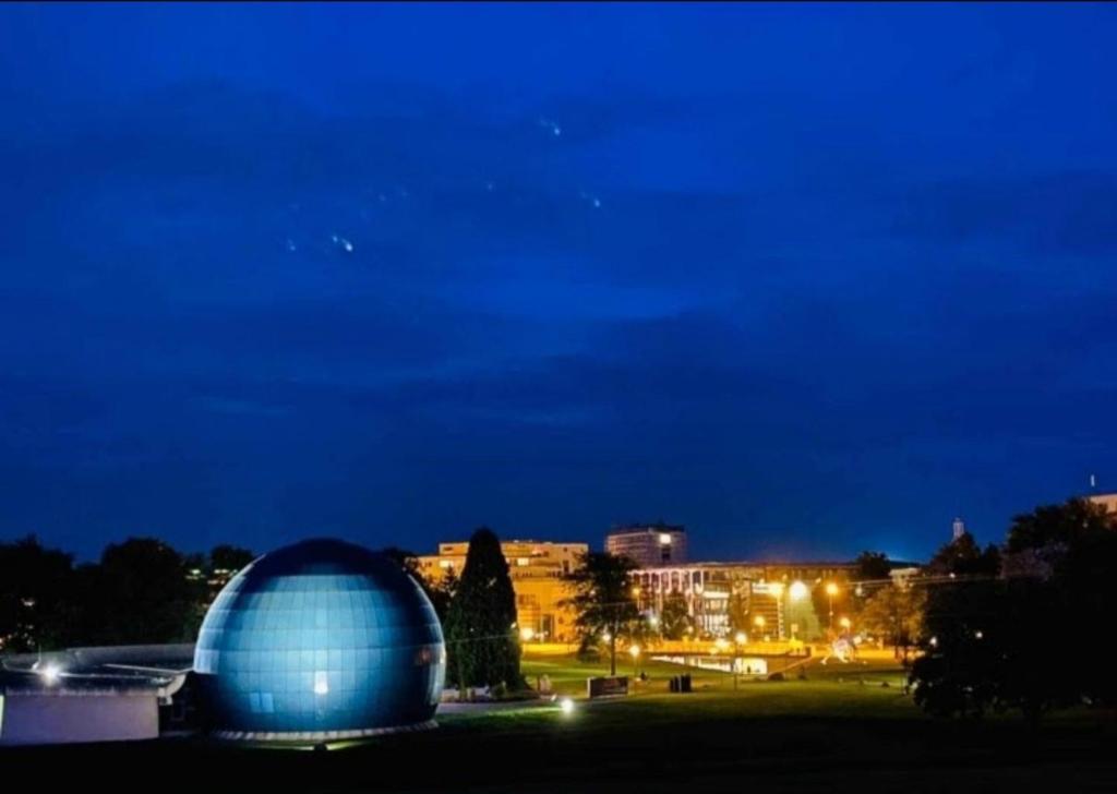 a blue domed building in a park at night at " Die Wolfs Burg" 50qm & zentrumsnah in Wolfsburg