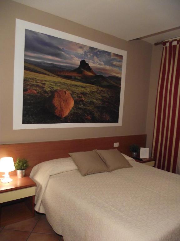 Postel nebo postele na pokoji v ubytování La Corte Albergo