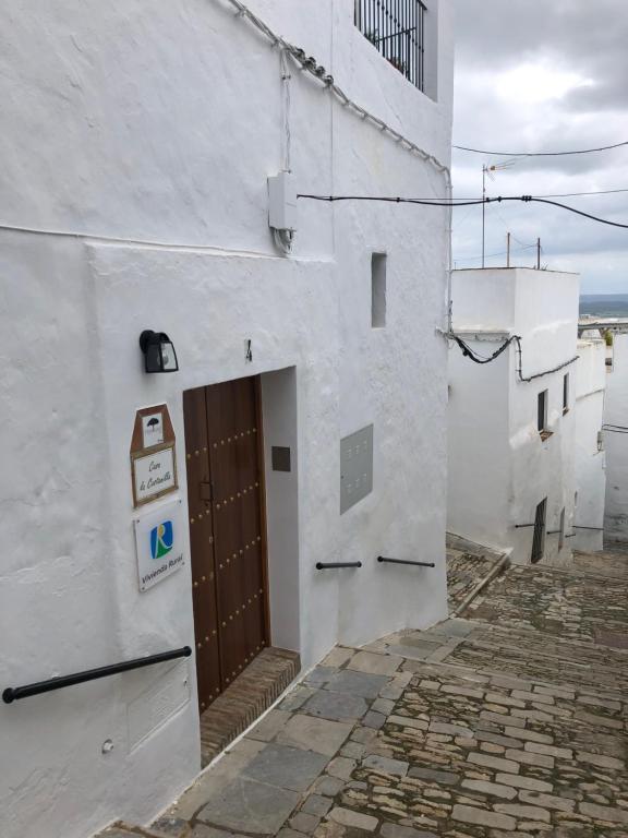 a white building with a door on the side of it at Apartamentos Casa la Costanilla in Vejer de la Frontera