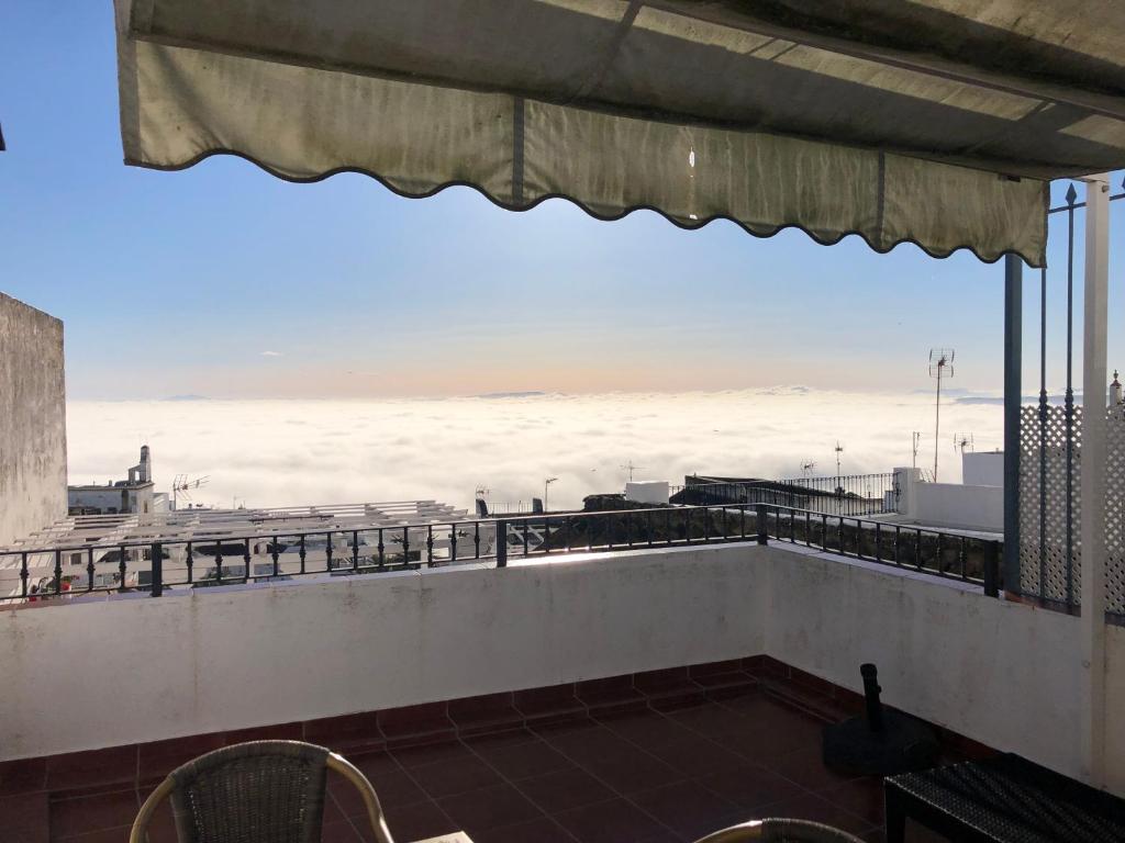 a view of the ocean from the balcony of a building at Apartamentos Casa la Costanilla in Vejer de la Frontera