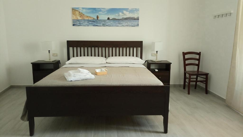 uma cama num quarto com duas cadeiras e uma cama sidx sidx em Holiday Home Tarinuzza em Lipari
