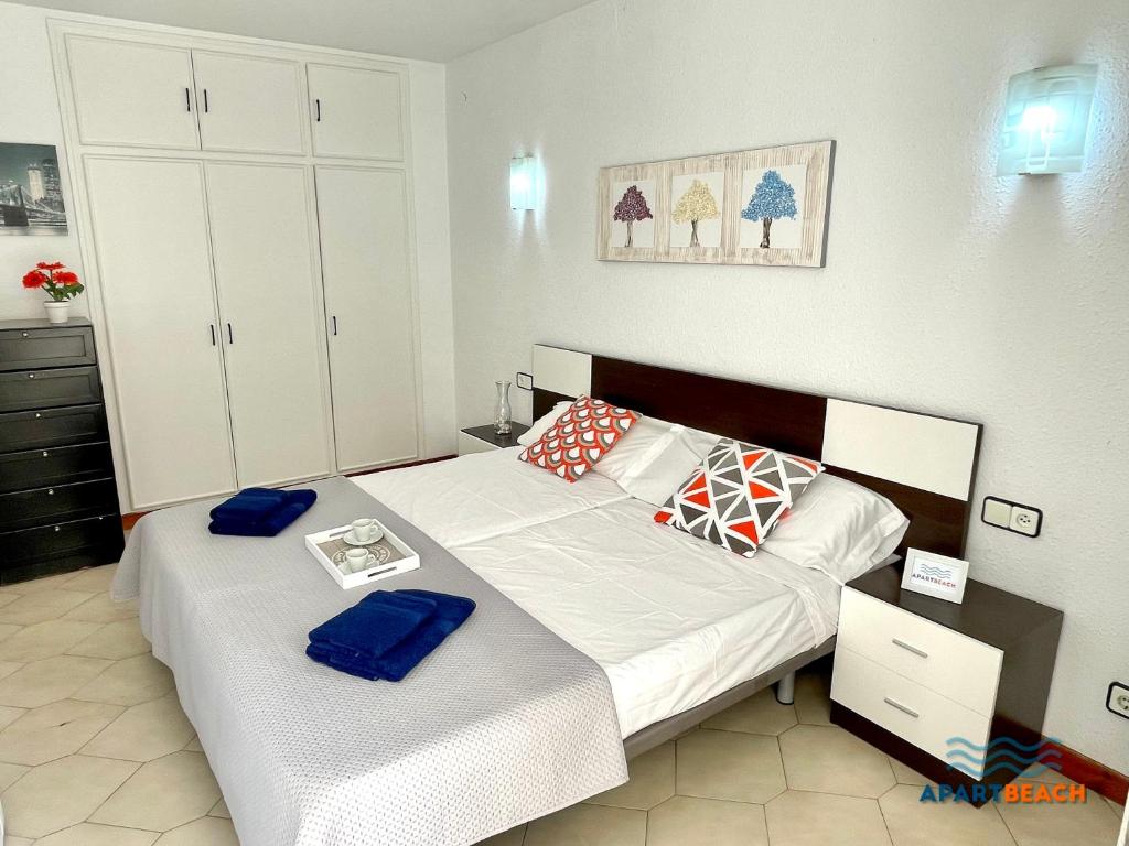 a bedroom with two beds with towels on them at APARTBEACH NOVELTY CLIMATIZADO y VISTAS PLAYA in Salou