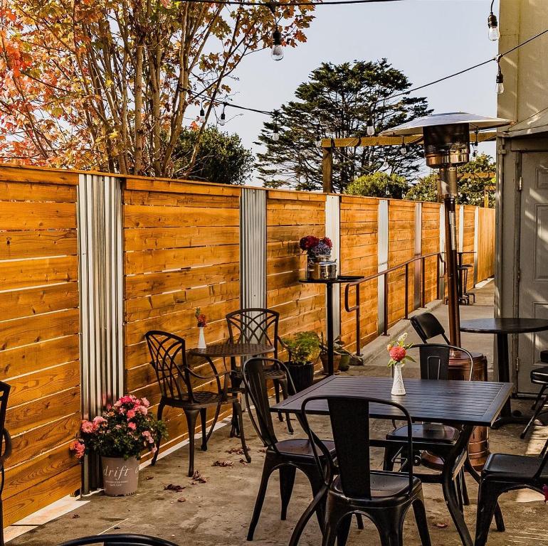 a patio with tables and chairs and a fence at The Inn at 2nd & C in Eureka