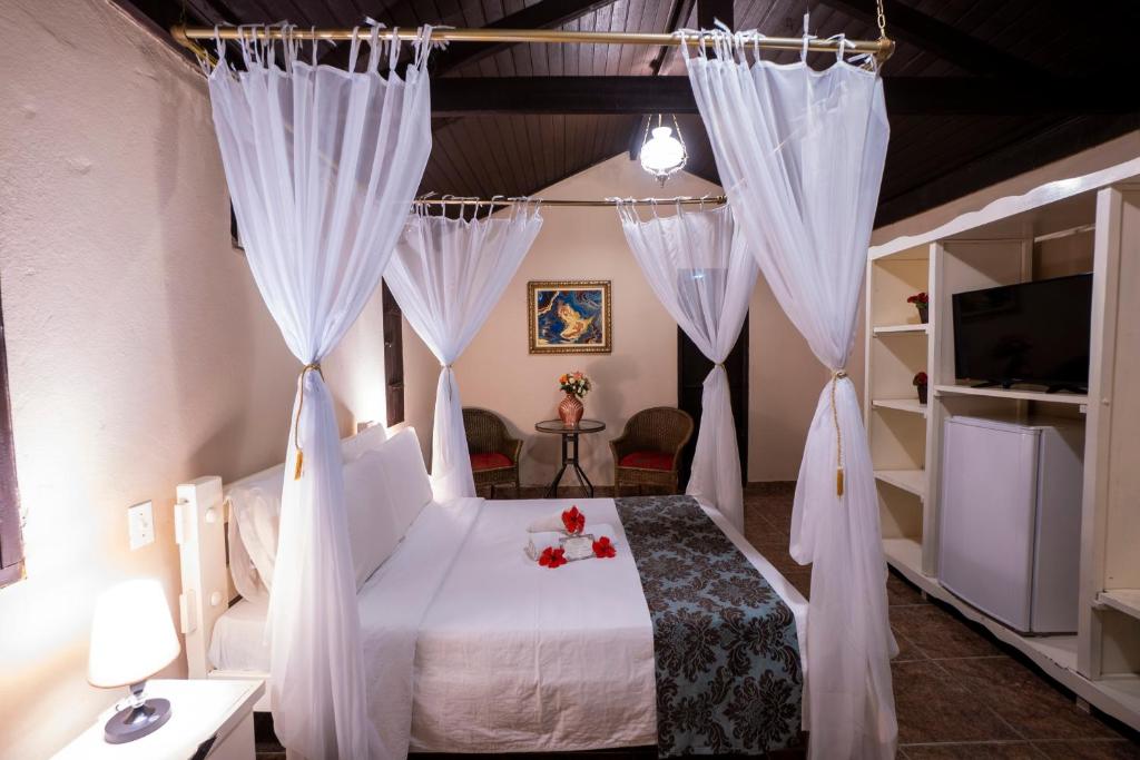 Postel nebo postele na pokoji v ubytování Pousada Villa das Pedras
