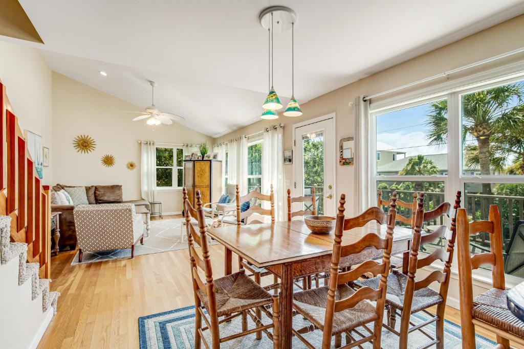 a dining room with a table and chairs at Compass Rose II in Folly Beach