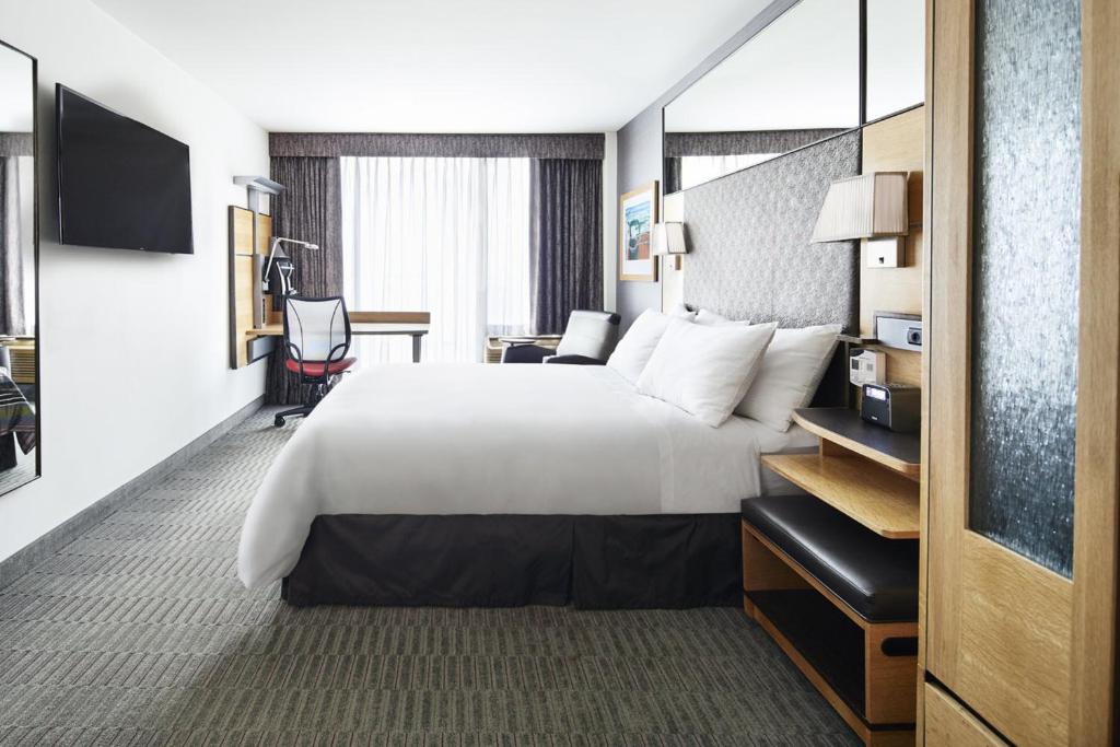 a hotel room with a large bed and a desk at Wheeler Hotel in Bronx