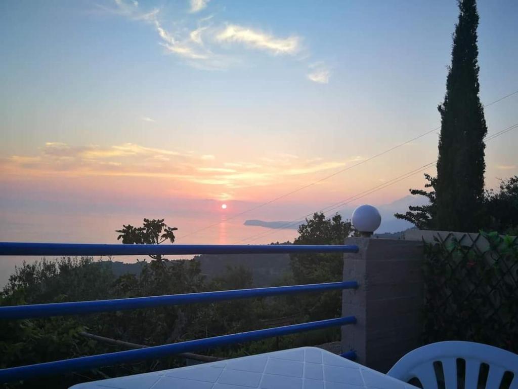a view of the sunset from the balcony of a house at Rooms to let Spiropali in Piqeras