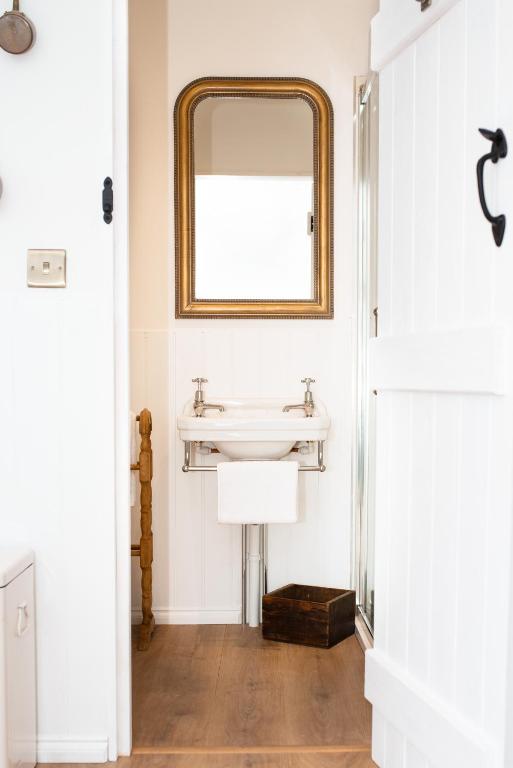 a bathroom with a sink and a mirror at Drift View Shepherds Hut in Melton Mowbray