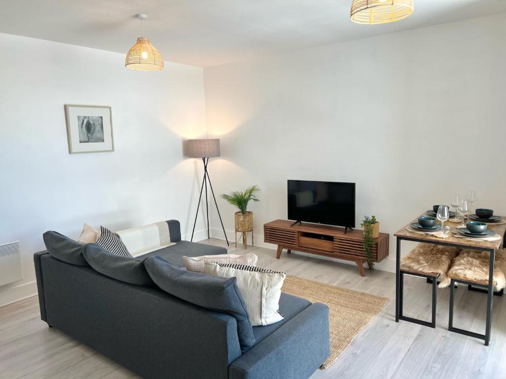 een woonkamer met een bank en een flatscreen-tv bij 2 Bedroom Serviced Apartment with Free Parking, Wifi & Netflix, Basingstoke in Basingstoke