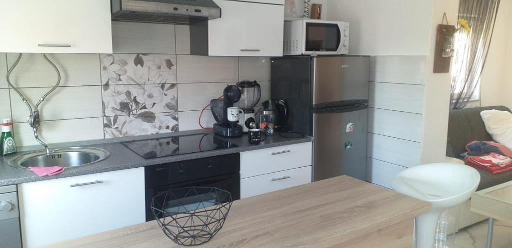 małą kuchnię ze zlewem i lodówką w obiekcie Apartman Zvončica w mieście Vrsi