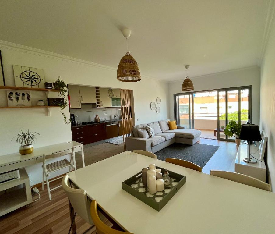 a living room with a table and a couch at My Place in Portimão