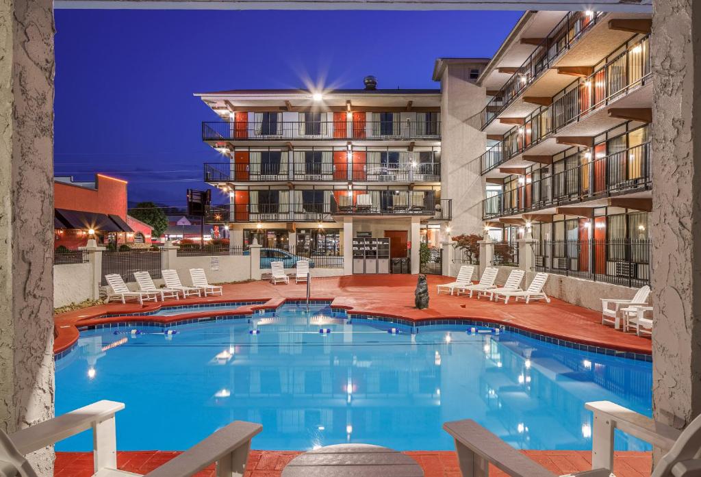 a swimming pool in a hotel at night at Americana Inn a Travelodge by Wyndham in Pigeon Forge