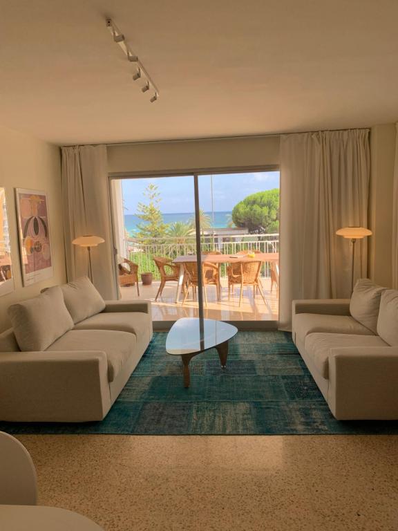 a living room with two couches and a table at EPIS - large luxury apartment with sea view in Benicàssim