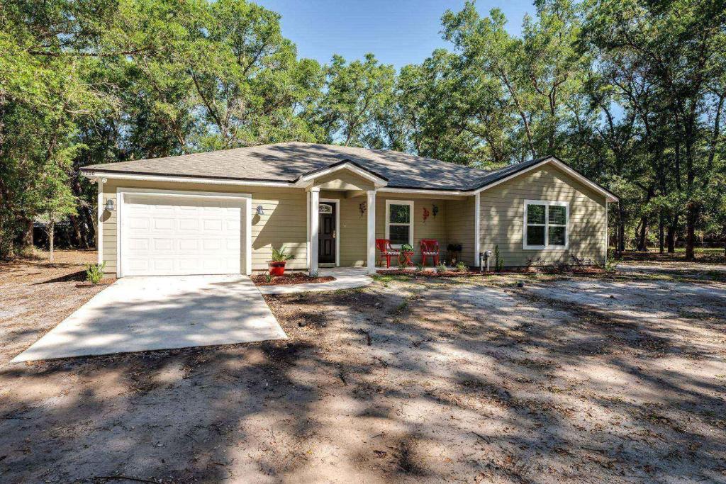 a small house with a garage in a yard at Moody Oaks in Orange Park