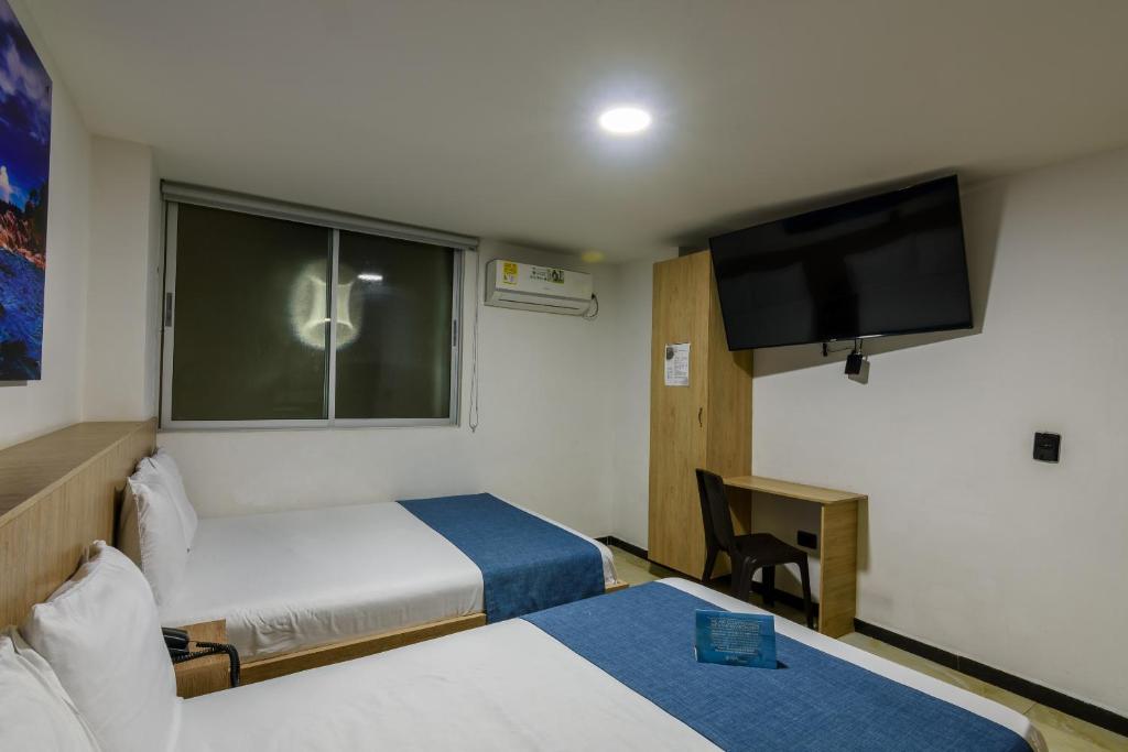 Postel nebo postele na pokoji v ubytování Hotel Med Estadio