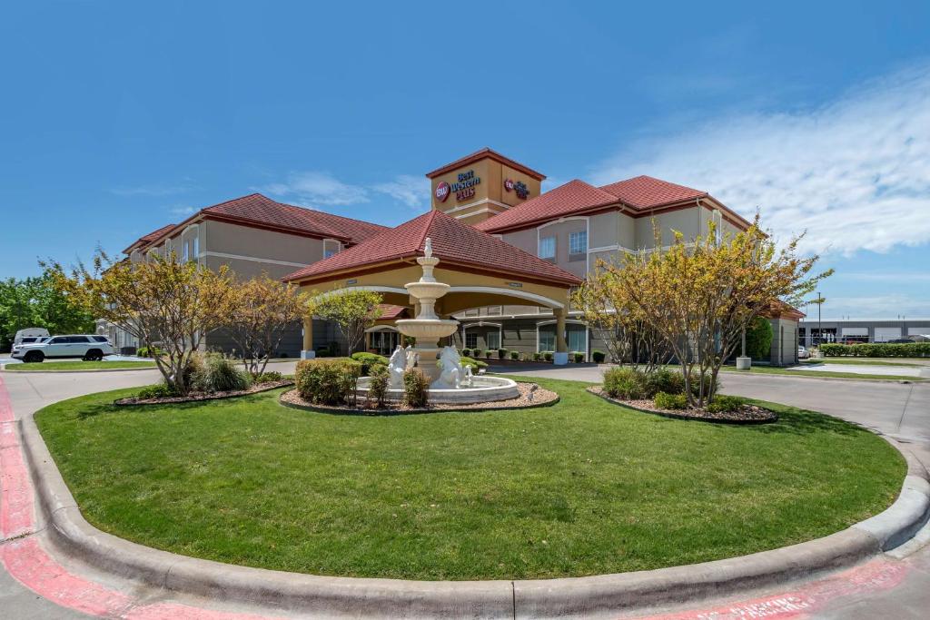 un parc en face d'un bâtiment avec une fontaine dans l'établissement BEST WESTERN PLUS Monica Royale Inn & Suites, à Greenville