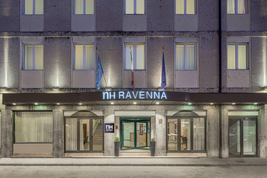 a large building with a sign on the side of it at NH Ravenna in Ravenna