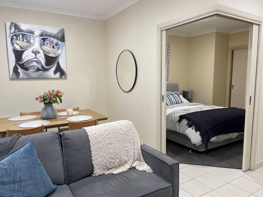 a living room with a couch and a bed at Morgan Place - Central Melbourne CBD Apartment on Flinders Lane Late Check-Out, Complimentary Welcome Hamper in Melbourne