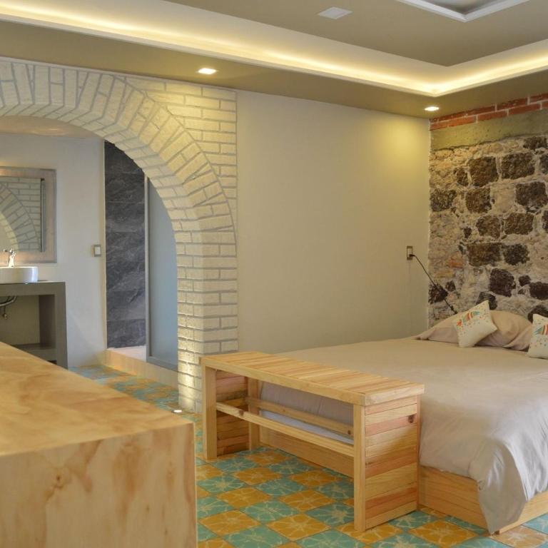 Postel nebo postele na pokoji v ubytování PEQUEÑO ENCANTO Hotel Boutique