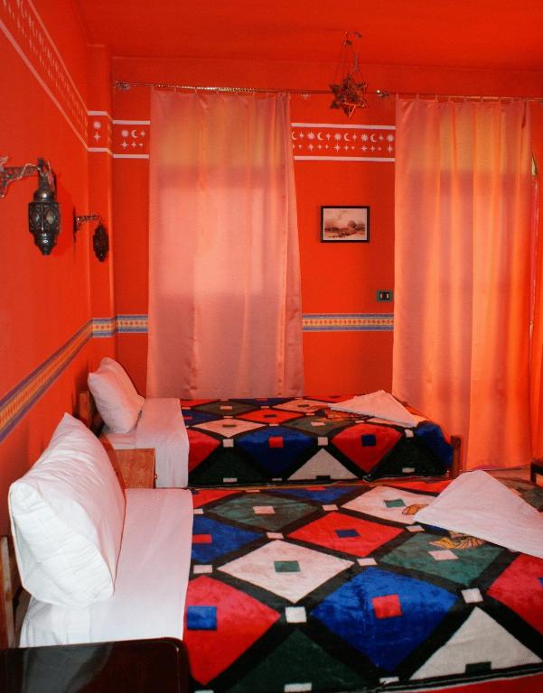 Postel nebo postele na pokoji v ubytování Ramsess Hostel