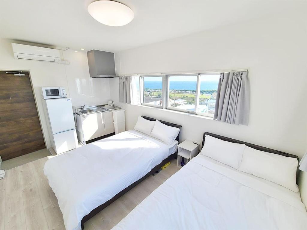 Postel nebo postele na pokoji v ubytování HOTEL Kuu