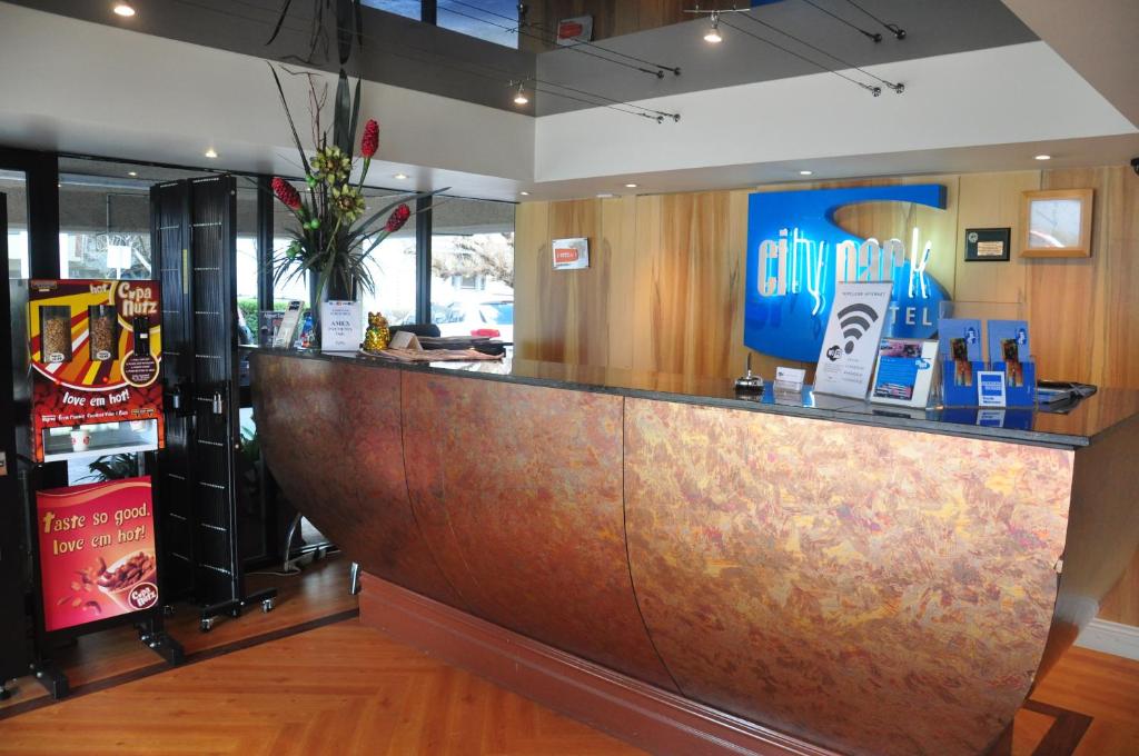 a bar in a restaurant with a large wooden counter at City Park Hotel in Melbourne
