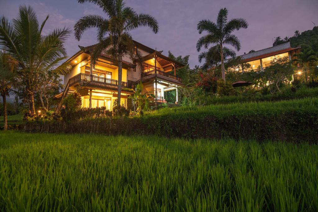 una casa en medio de un campo de arroz en Lesong Hotel and Restaurant en Munduk