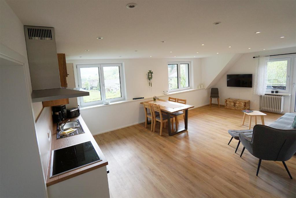 a living room with a kitchen and a dining room at Gummeneck - Stubenhof, Black Forest in Simonswald