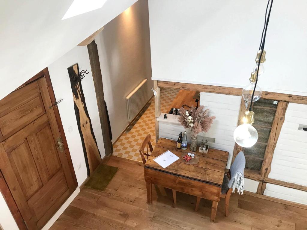 a room with a wooden table and a wooden door at Wohnung Alter Heuboden im Fachwerk bei Bonn Alfter in Heidgen