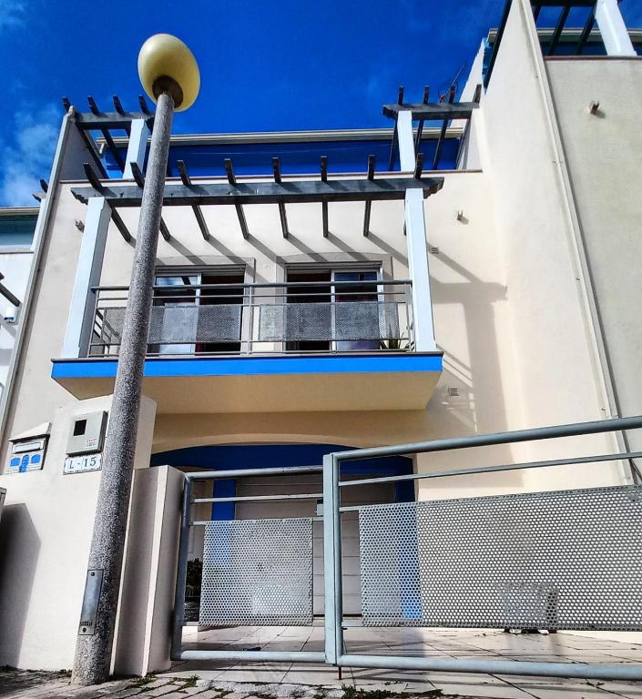 a building with a balcony on the side of it at House Victoria in Nazaré