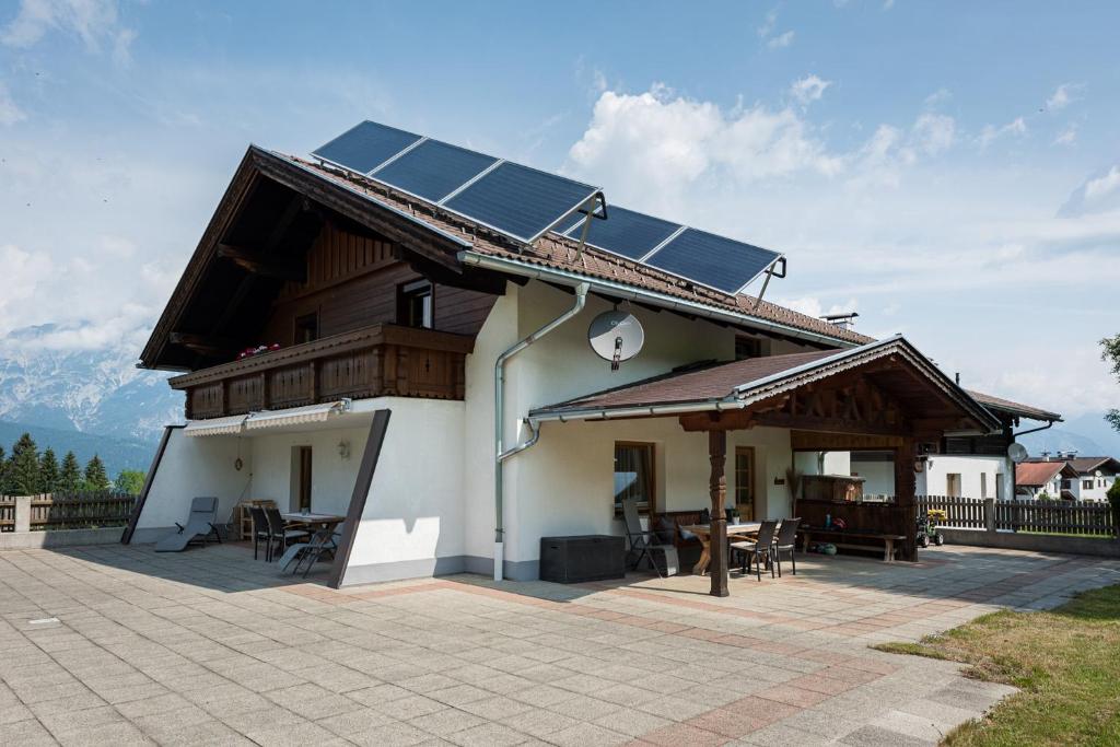 a house with solar panels on the roof at Bauernhof Ferienwohnungen Sennhof in Weerberg