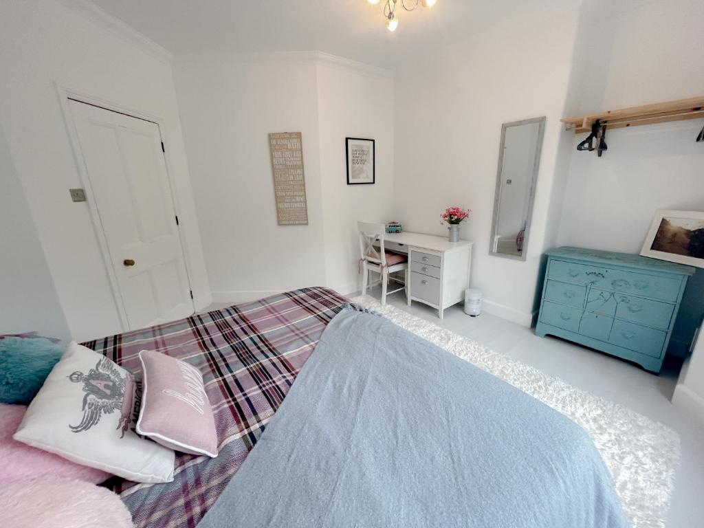 a bedroom with a bed and a desk in it at Queens Park View - 1 Bedroom in Bournemouth