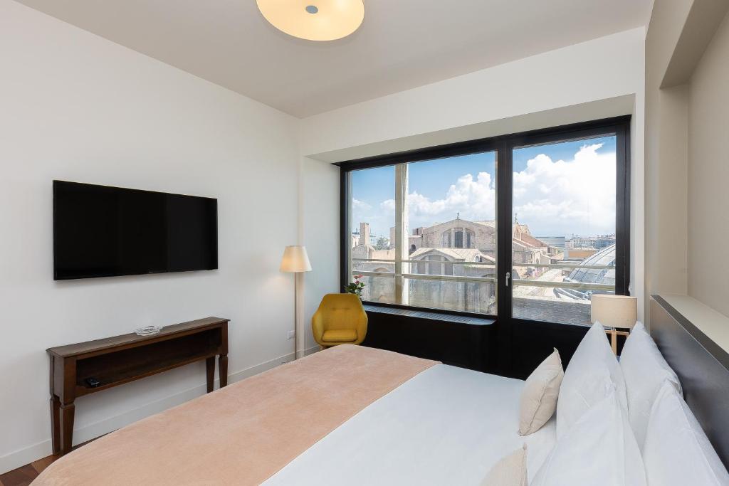 a bedroom with a large bed and a large window at Amazing Via Parigi in Rome