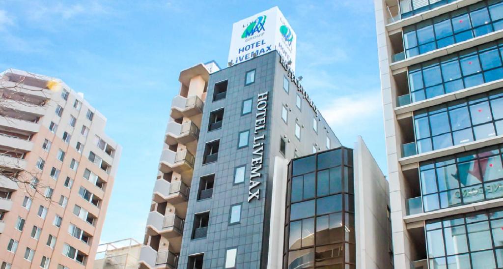 a tall building with a sign on top of it at HOTEL LiVEMAX Tokyo Bakurocho in Tokyo