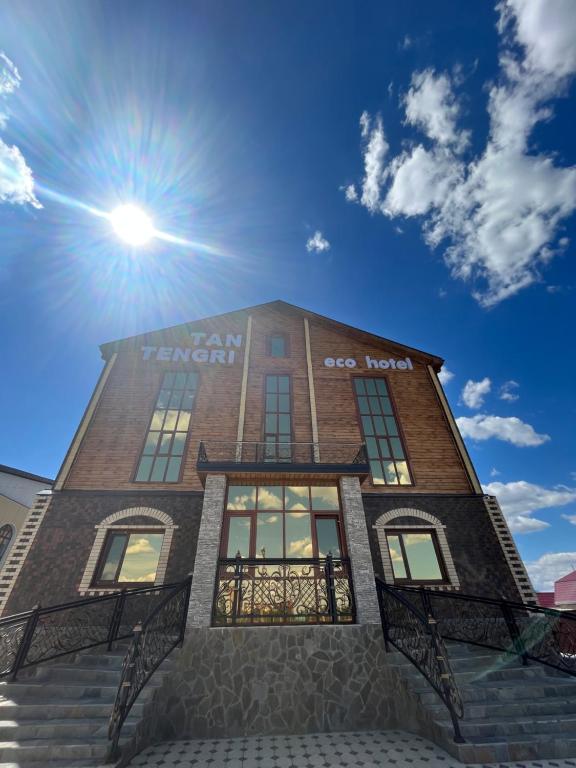 a building with the sun on top of it at Eco Hotel Tan Tengri in Kostanay