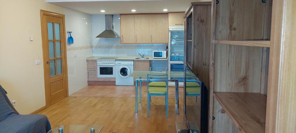 a kitchen with a table and chairs in a room at Vivienda Sierra de San Marcos in Golmayo
