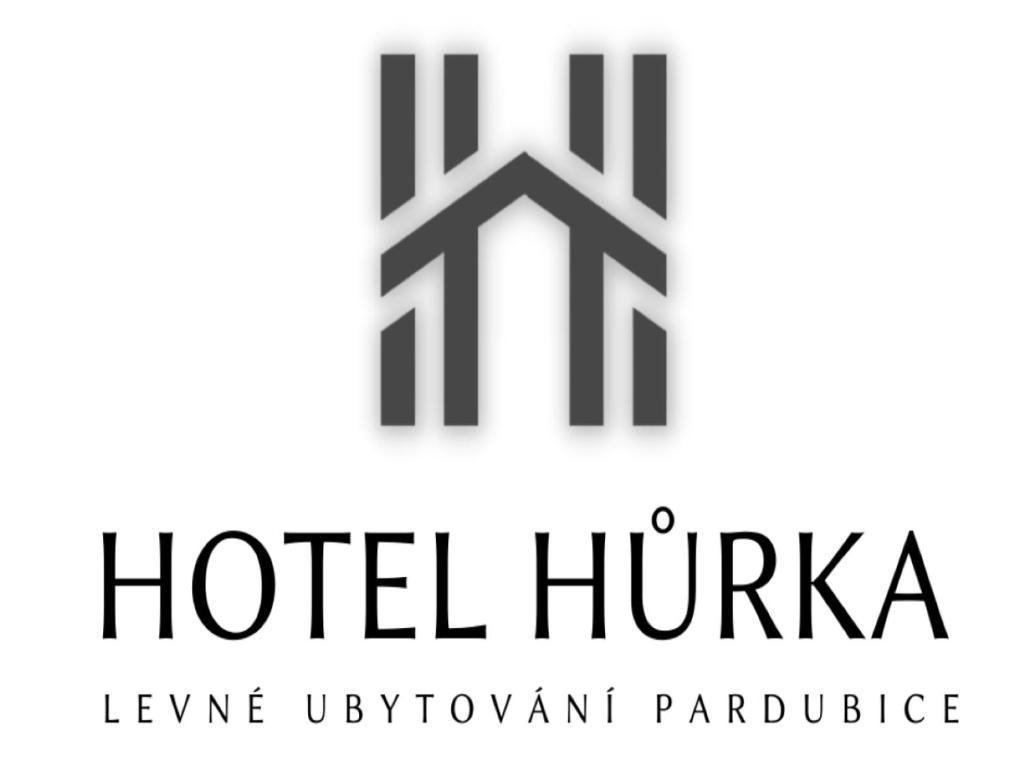 a logo for hotel huikka in black and white at Hotel Hůrka in Pardubice