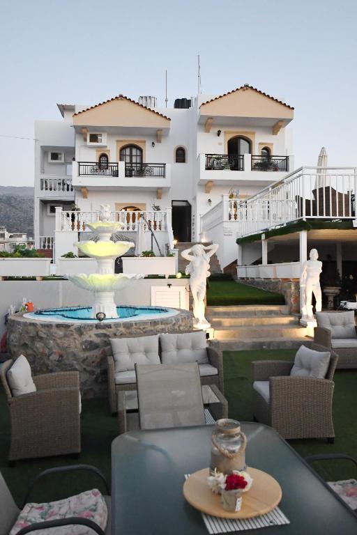 a view of a house with a table and chairs at Olympus Studios in Malia