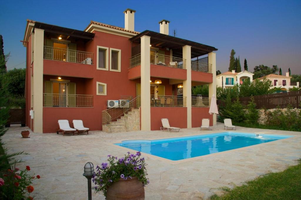 a house with a swimming pool in front of it at Villa Maria Kefalonia in Kaligata