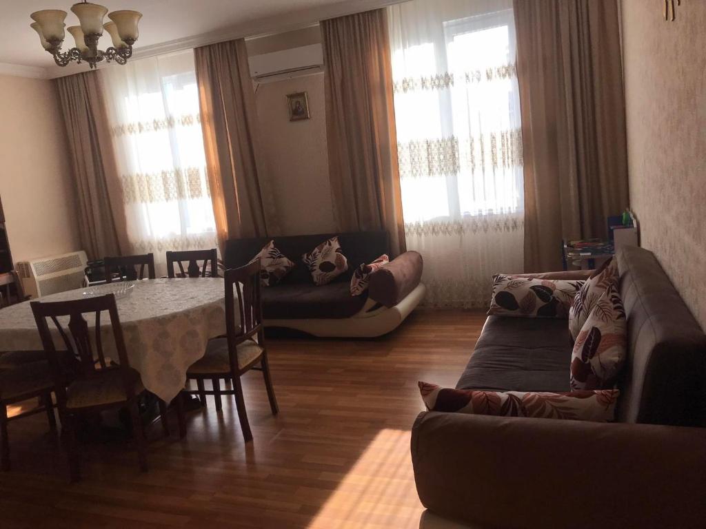 a living room with a table and a dining room at Mariami's sweet home in Kobuleti