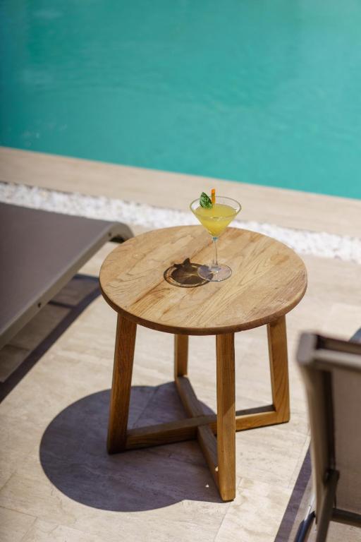 a small wooden table with a martini glass on it at Costa Maya Bodrum in Bodrum City