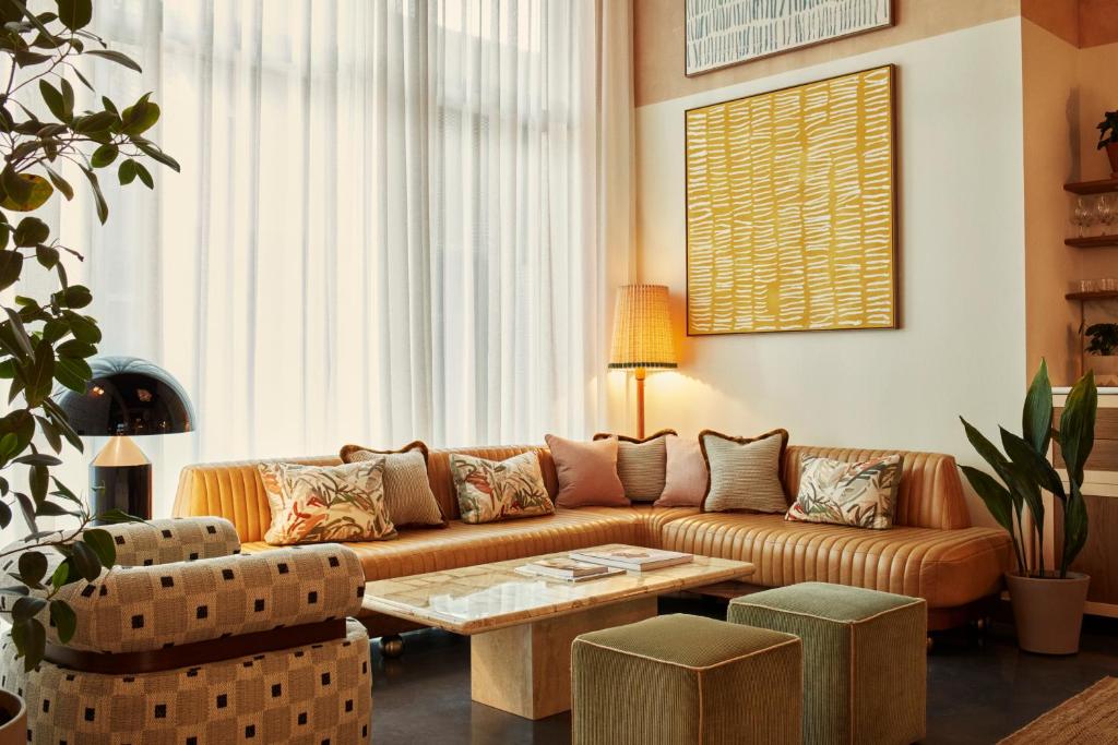 a living room with a couch and a table at The Hoxton, Poblenou in Barcelona