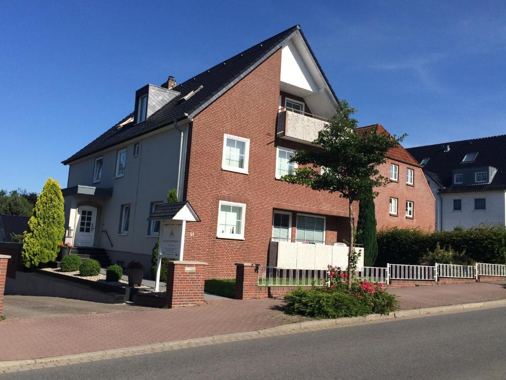 a red brick house with a black roof at 3C-Appartements in Scharbeutz