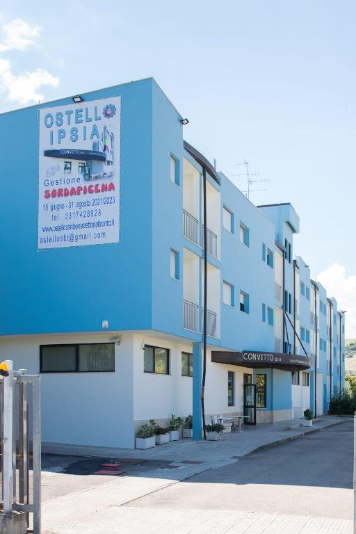 a building with a sign on the side of it at Ostello Ipsia in San Benedetto del Tronto